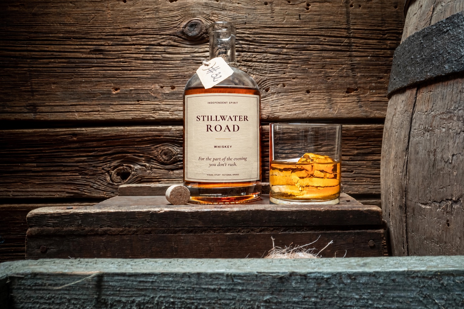 Stillwater Road whiskey bottle with cream and oxblood label on a wooden table